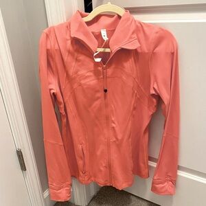 Lululemon define Luon jacket. Never been worn, coral color